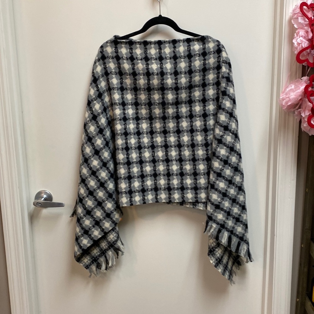Gray, black and cream plaid poncho with fringes bottom.